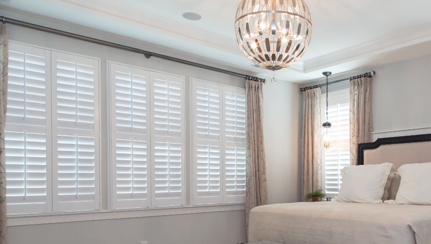 Plantation shutters paired with curtains